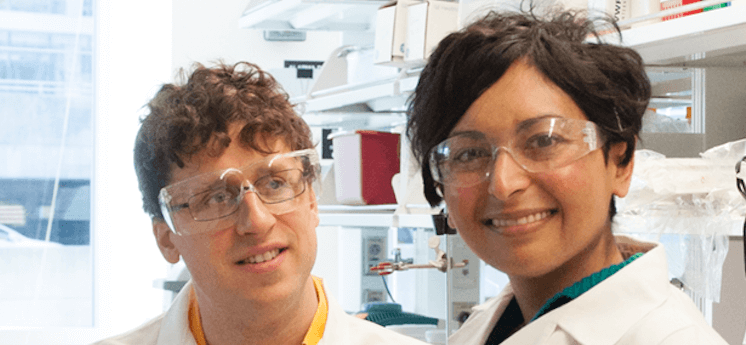 Male and Female in lab smiling